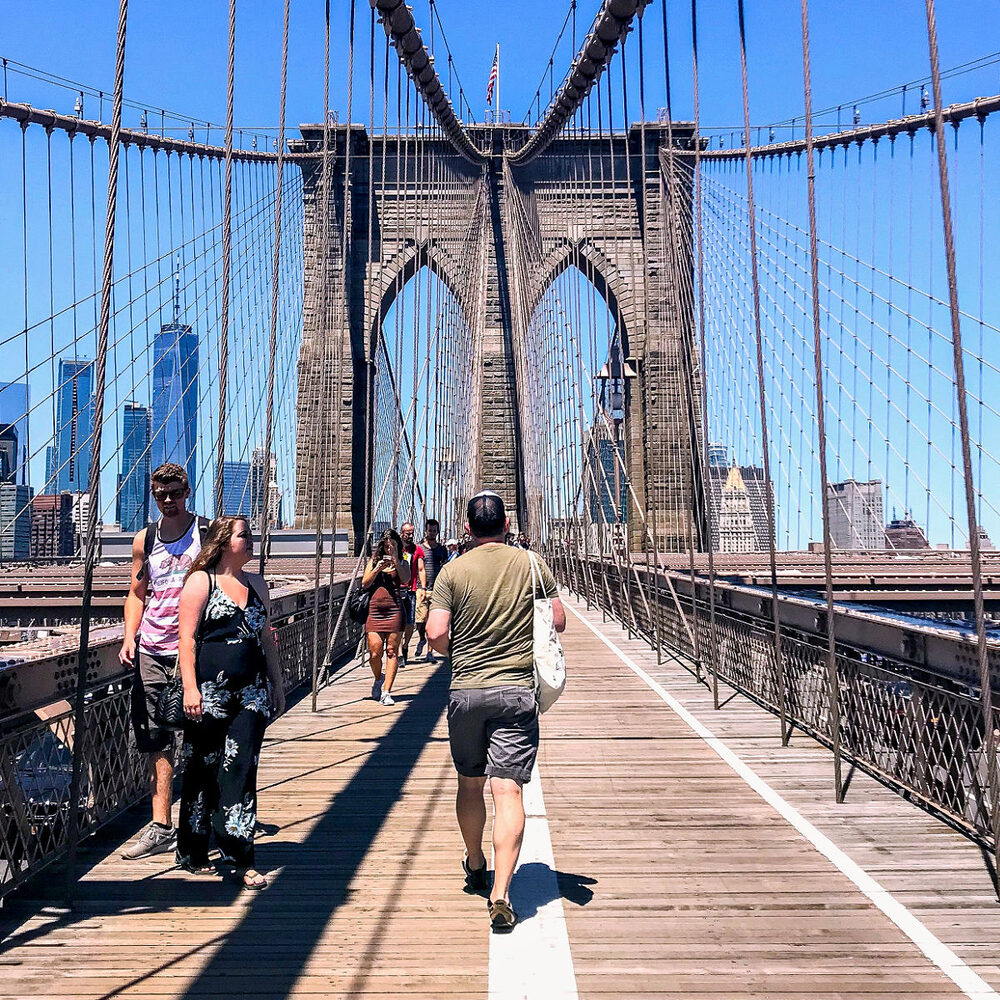 Brooklyn Bridge pedestrian walkway with Lower Manhattan skyline — Brooklyn Bridge bike route from Astra Bike Rentals NYC